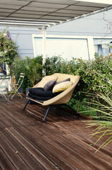 Solace rattan loveseat on a terrace, wide view