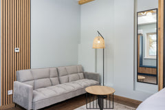 Aria dove grey click-clack sofa cum bed in a modern living room