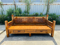 Shahi daybed frame showing hand-carved back panels and drawers