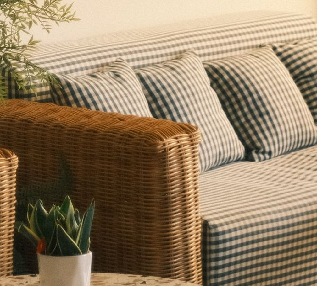 Close-up of the woven rattan arm and gingham cushions