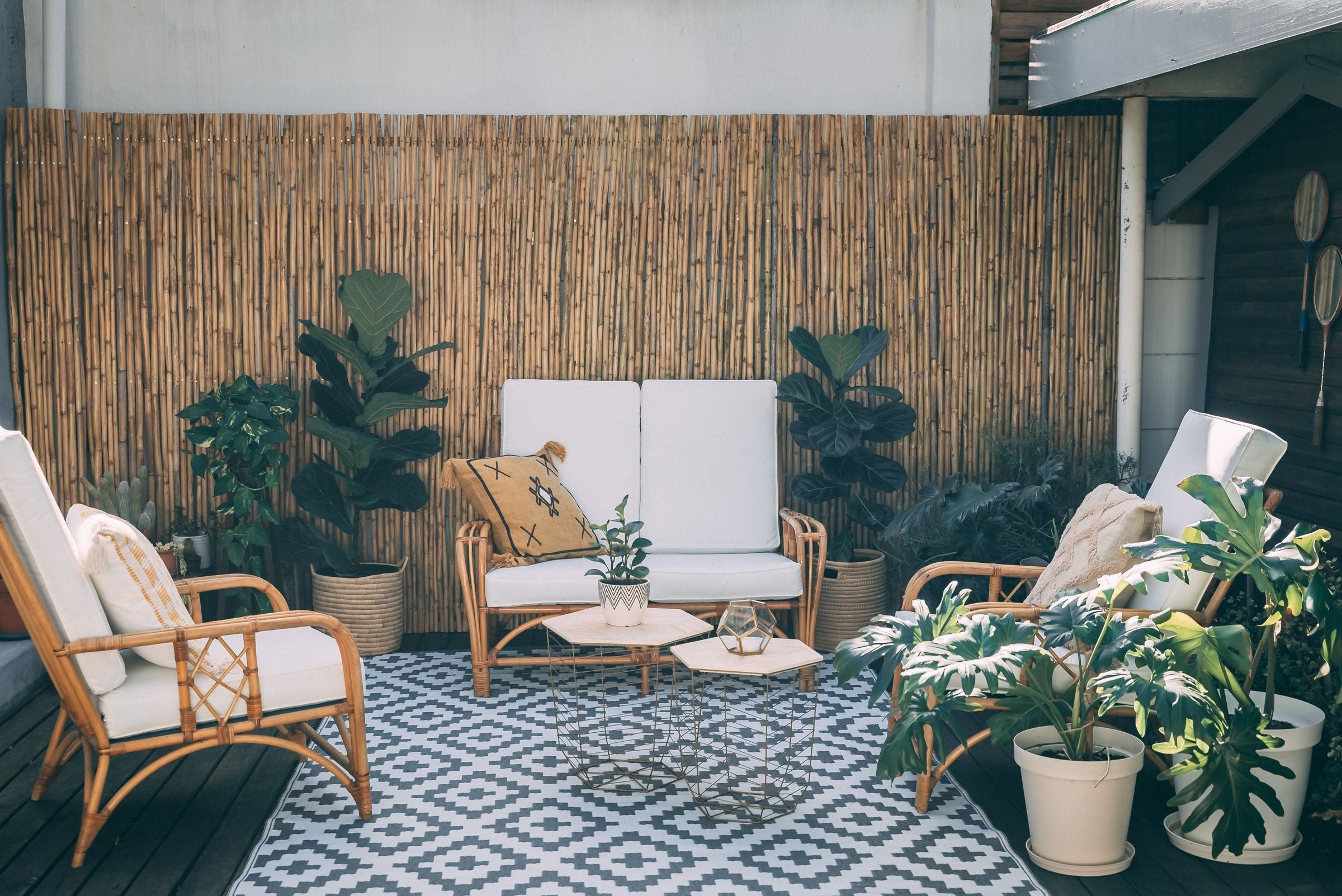 Riviera rattan loveseat with matching armchairs on a patio
