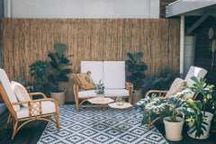 Riviera rattan loveseat with matching armchairs on a patio