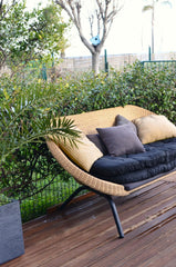 Solace rattan loveseat, front three-quarter view